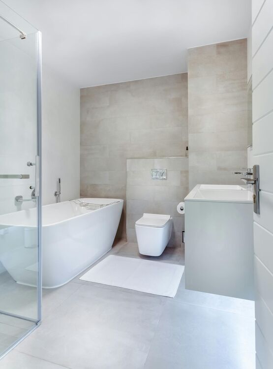 a newly remodeled bathroom featuring new click together waterproof vinyl tile flooring