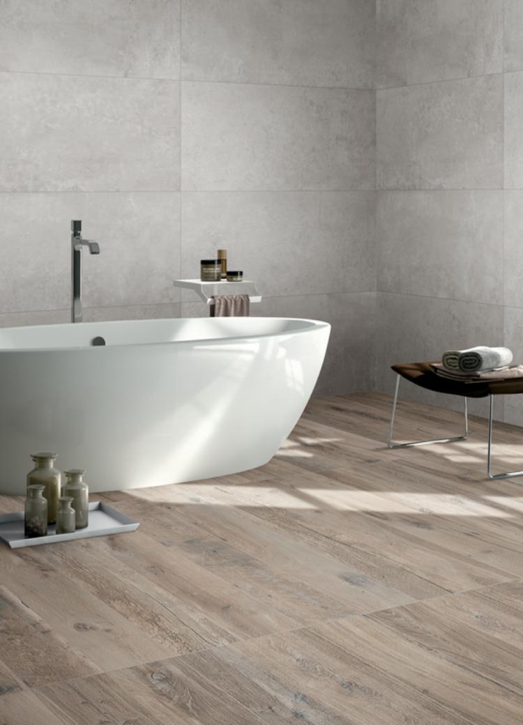 wood look tile flooring in bathroom with bathtub